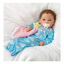 Baby doll Rylee in blue pajamas with cloud and star design, holding a pink blanket and pacifier, lies on a soft surface.