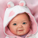 Ashton Drake Cutest Baby Portrait Savana Baby Doll wearing a white hood with pink hearts, smiling with blue eyes.