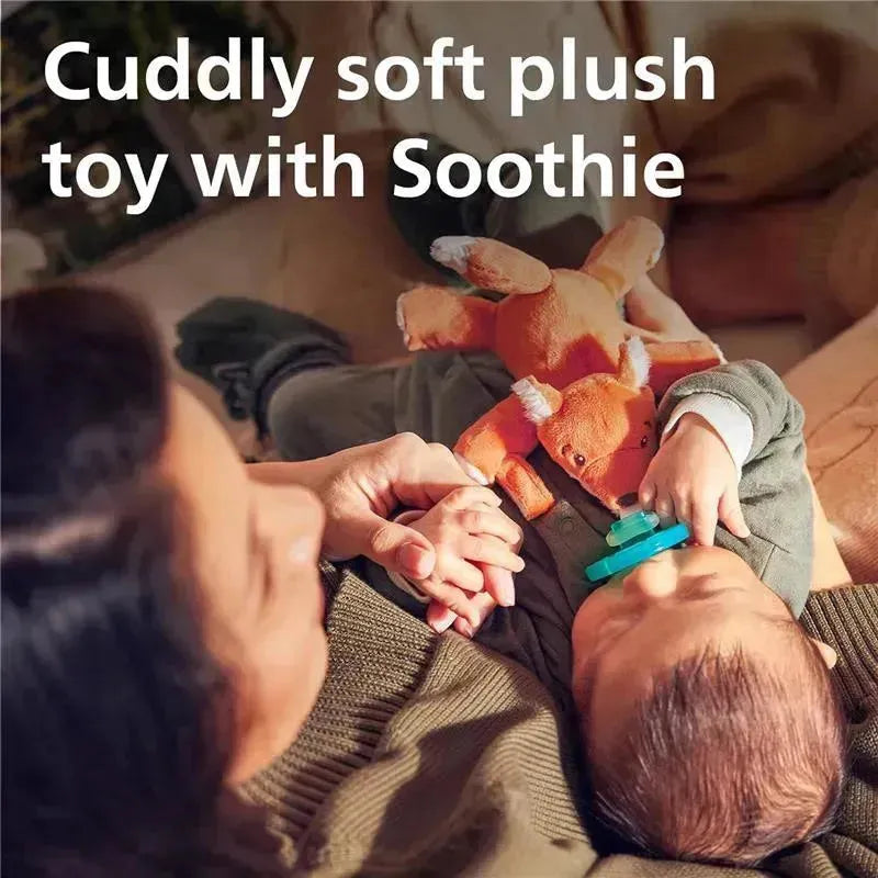 Cuddly soft orange fox plush toy with attached Soothie pacifier, being held by a baby and a caregiver.