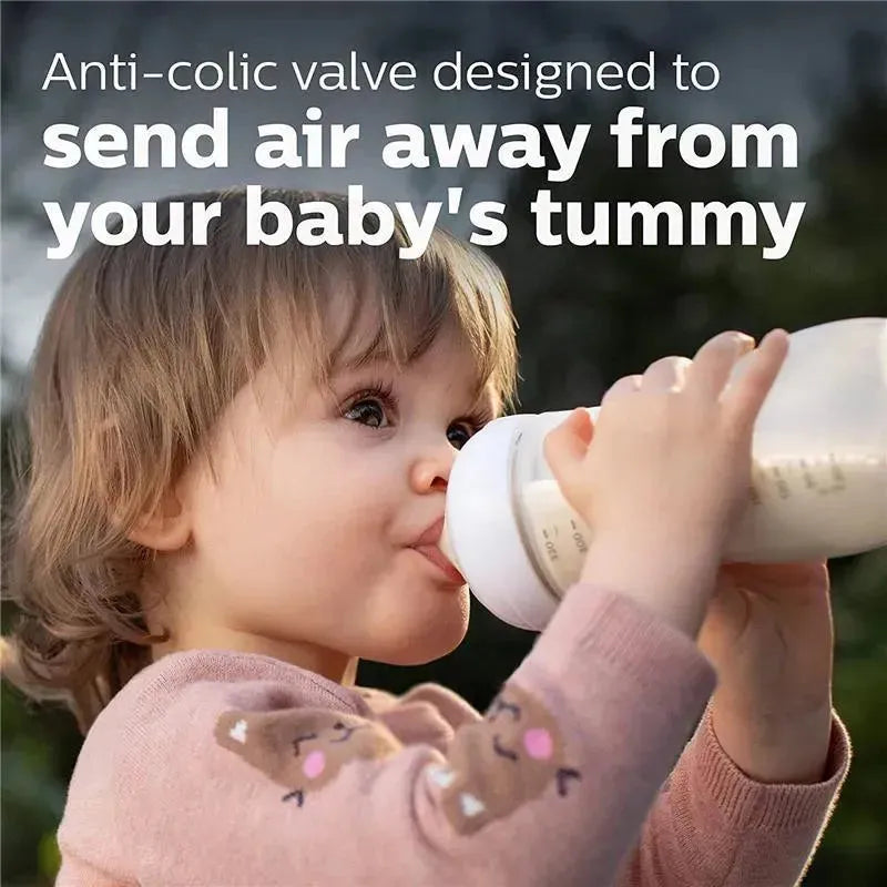 Toddler drinking from an Avent 11oz baby bottle, featuring an anti-colic valve to reduce air intake.