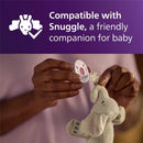 A person holds a Avent Soothie pacifier, attaching it to a plush elephant toy, with text indicating compatibility with Snuggle.