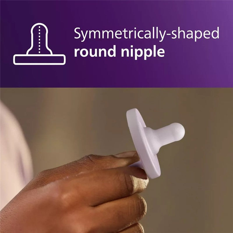Avent 2Pk Soothie Pacifier in fresh lilac and pastel pink, showing a hand holding the pacifier with a round nipple design.