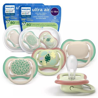 Avent 2Pk Ultra Air Pacifiers for 6-18 months, featuring leopard print and tropical designs, in assorted colors and shapes.