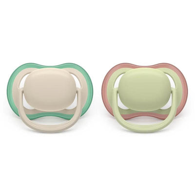 Two Avent Ultra Air pacifiers for ages 6-18 months in sand and pastel warm green colors, designed for soothing infants.