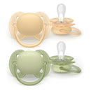 Avent 2Pk Ultra Soft Pacifier for ages 6-18 months in beige and pastel warm green colors, featuring a rounded shape and soft silicone nipples.
