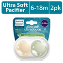 Avent 2-pack ultra soft pacifiers for infants aged 6-18 months in beige and pastel warm green, featuring a sterilizing case.