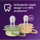 Two Avent Ultra Soft pacifiers for ages 6-18 months in beige and pastel warm green colors, featuring orthodontic design and BPA-free label.