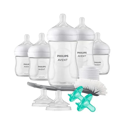 Natural baby bottle gift set from Philips Avent, featuring four bottles, nipples, a cleaning brush, and bottle caps.