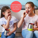 Insulated food jar by B.box in lilac pop color, featuring removable handles, with two girls eating strawberries.