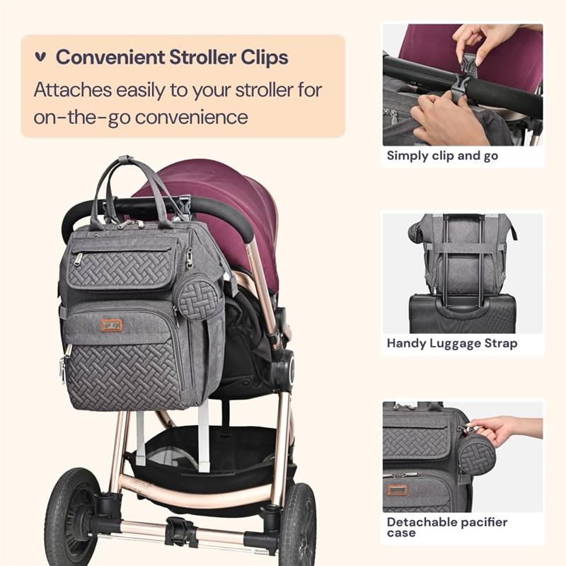 Diaper bag backpack in dark gray attached to a stroller, featuring stroller clips, a luggage strap, and a detachable pacifier case.