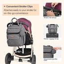 Diaper bag backpack in dark gray attached to a stroller, featuring stroller clips, a luggage strap, and a detachable pacifier case.