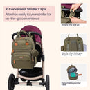 BabbleRoo army green diaper bag backpack attached to a stroller, highlighting convenient clips and a detachable pacifier case.