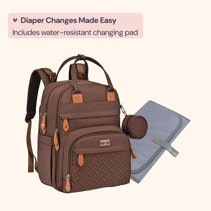 Brown BabbleRoo travel essentials baby bag with leather accents, includes a water-resistant changing pad.