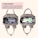 Khaki BabbleRoo Travel Essentials Baby Bag with changing pad, showing spacious interior with 17 pockets and assorted baby items.