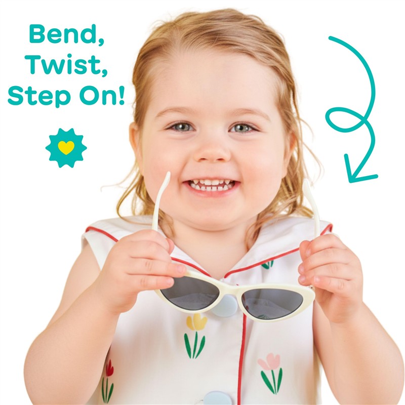 Children’s cat-eye shaped UV sunglasses in white held by a smiling toddler wearing a floral dress, with playful text.