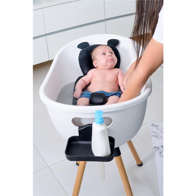 Luxury baby bathtub with wooden stand, featuring a baby in water and caregiver gently washing.