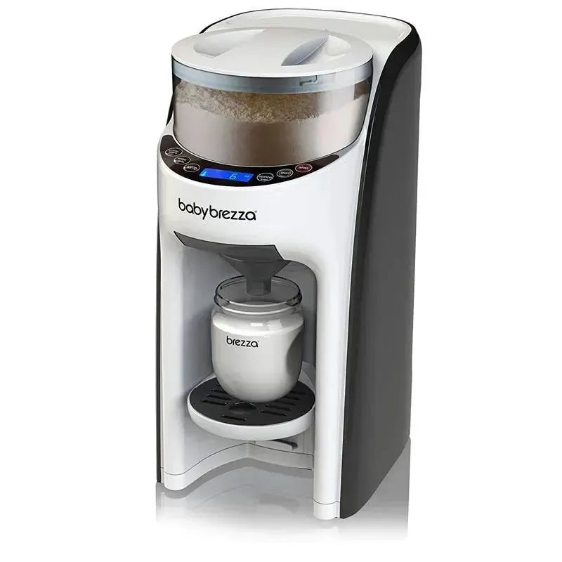 Baby Brezza Baby Formula Pro Advance, a white and black automatic formula maker, dispenses formula into a glass container.