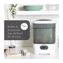 One Step Baby Bottle Sterilizer and Dryer by Baby Brezza, shown sterilizing bottles with a text overlay about 24-hour sterilization.