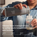 Baby Brezza Super Fast Portable Bottle Warmer in black, displaying a temperature of 98°F while pouring milk into a bottle.