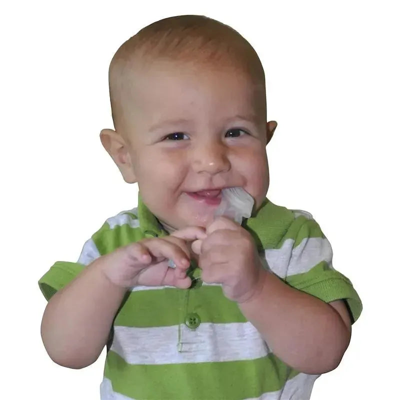 Smiling baby in a green and white striped shirt holding a small toothbrush for oral care.