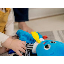 Colorful Baby Einstein Sensory Plush Octopus with a smiling face, striped clothing, and sensory textures, being held by a baby.