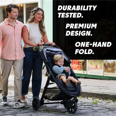 Single Baby Jogger City Mini GT3 stroller in Frosted Ivory with a smiling child inside, as a couple strolls together.