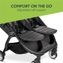 Double stroller with adjustable calf support, featuring two seats and a pitch black design by Baby Jogger.