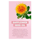 Safflower flower with vibrant yellow petals and green leaves on a pink background, highlighting its use for hair moisturizing.