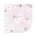 Flannel washcloth in purple with a dainty floral pattern featuring white flowers and green leaves.