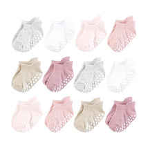 Twelve pairs of non-skid no show socks in mauve and neutral shades, featuring dotted grips on the soles.