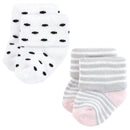 Set of four baby socks featuring two pairs: one with black dots on white and another striped in gray and pink.