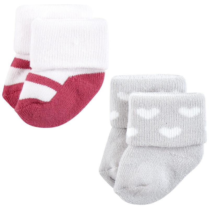 Twelve pairs of baby socks in pink and black designs, featuring striped and heart patterns, with cuffed tops.