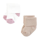 Soft terry socks for girls in pastel colors, featuring a white and pink pair alongside a beige pair.