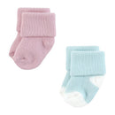 Two pairs of soft baby socks in pink and light blue with rolled cuffs, designed for girls.