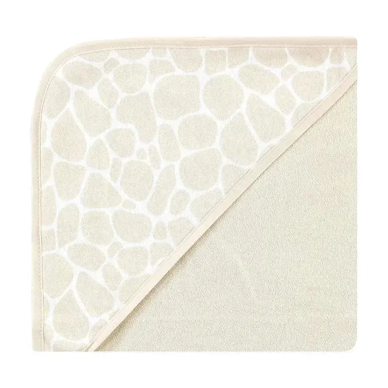 Cotton-rich hooded towel featuring a cream color with a gentle giraffe skin print, ideal for infants.