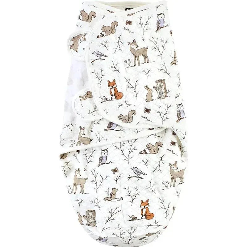 Quilted cotton swaddle wrap featuring an enchanted forest design with woodland animals like deer, foxes, and owls.