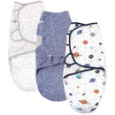 Three quilted cotton swaddle wraps for babies, featuring celestial designs like stars and planets in soft colors.
