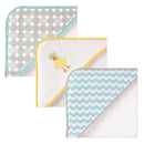 Three unisex baby hooded towels featuring a scuba duck design, polka dots, and wavy patterns in soft cotton terry.