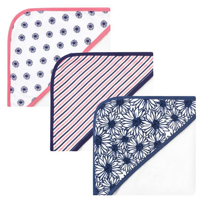 Three unisex baby organic cotton hooded towels featuring floral and striped designs in navy blue and pink.