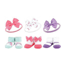 Set of six baby accessories including headbands and socks in pastel colors, featuring bows and rainbow designs.