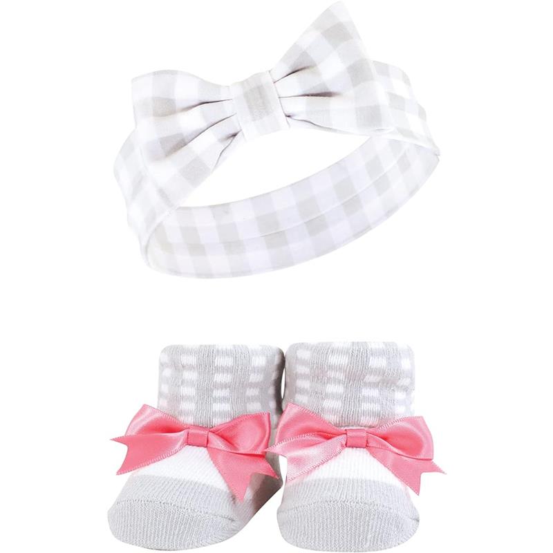 Pink and charcoal headband with bow and matching socks featuring pink bows and gray-striped detail.