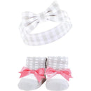 Pink and charcoal headband with bow and matching socks featuring pink bows and gray-striped detail.