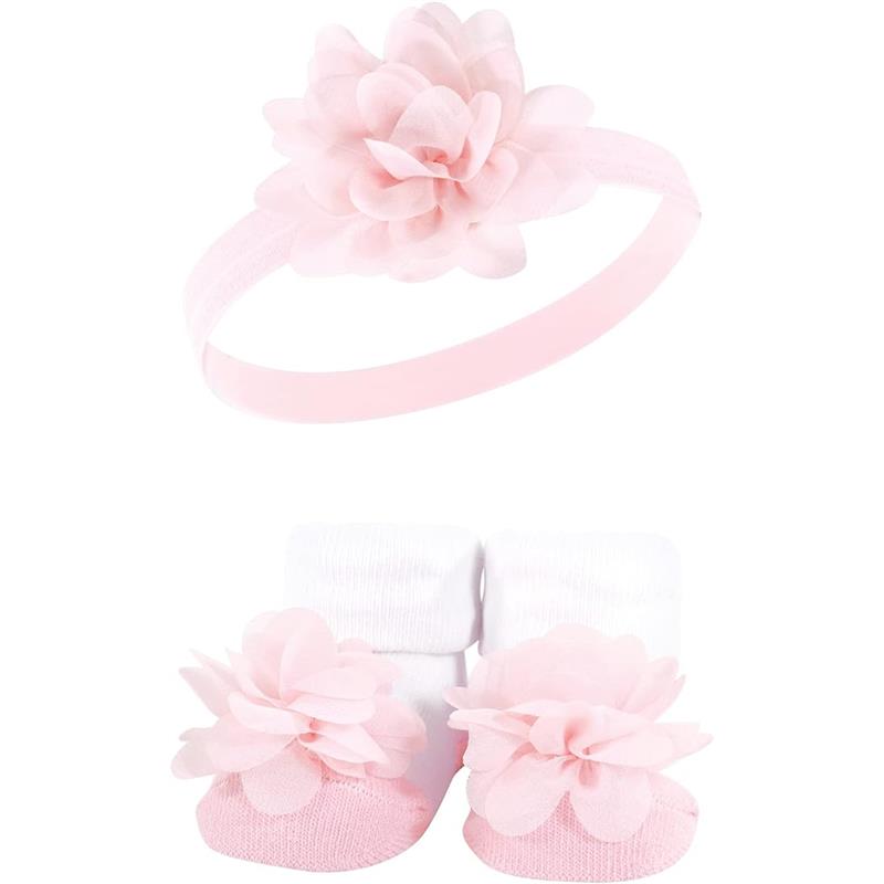 Pink headband with flower detail paired with matching pink and white socks featuring floral embellishments.