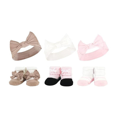 Set of six baby knit headbands and socks in pink and taupe, featuring bows and soft fabric.