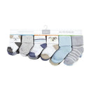 Twelve pairs of baby socks featuring various dog-themed designs and colors, arranged on a retail display card.