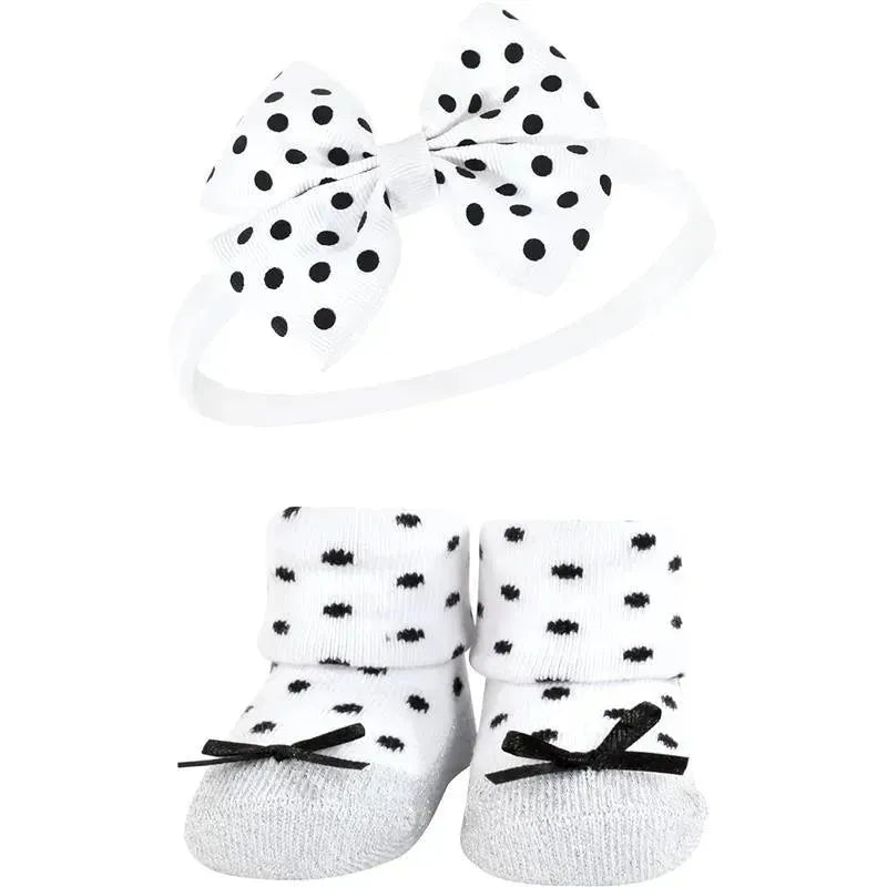 Black and silver baby girl headband with a polka dot bow and matching polka dot socks with black bows.