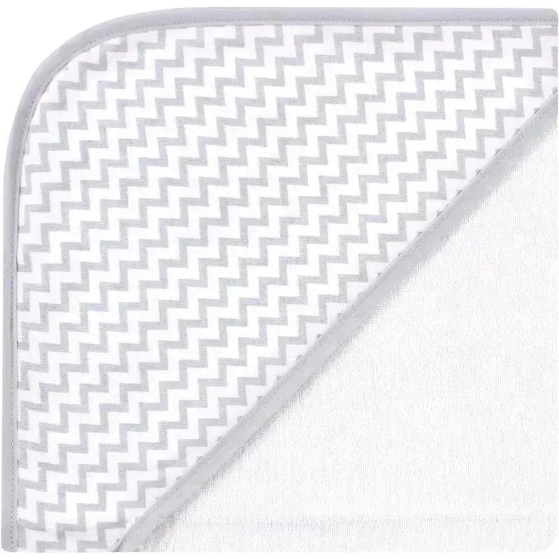 Hooded baby towel featuring a soft white body and a gray zigzag patterned hood. Ideal for bath time.