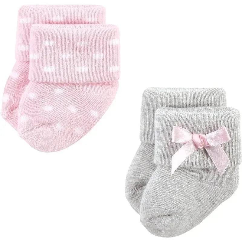 Pink polka-dot and gray socks for baby girls, featuring a folded cuff and a pink bow on the gray pair.