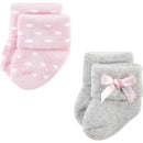 Pink polka-dot and gray socks for baby girls, featuring a folded cuff and a pink bow on the gray pair.