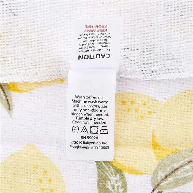 Cotton flannel receiving blanket with lemon print and care label instructions from Baby Vision.
